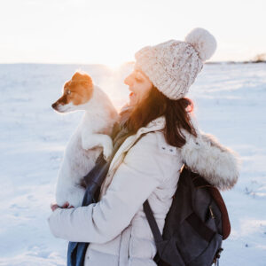 Photo of a dog being held by owner on a Winter day