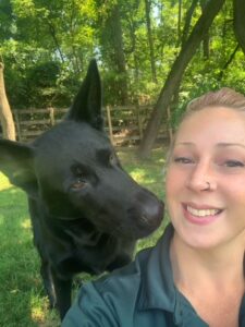 Image of a dog and its trainer taking a selfie